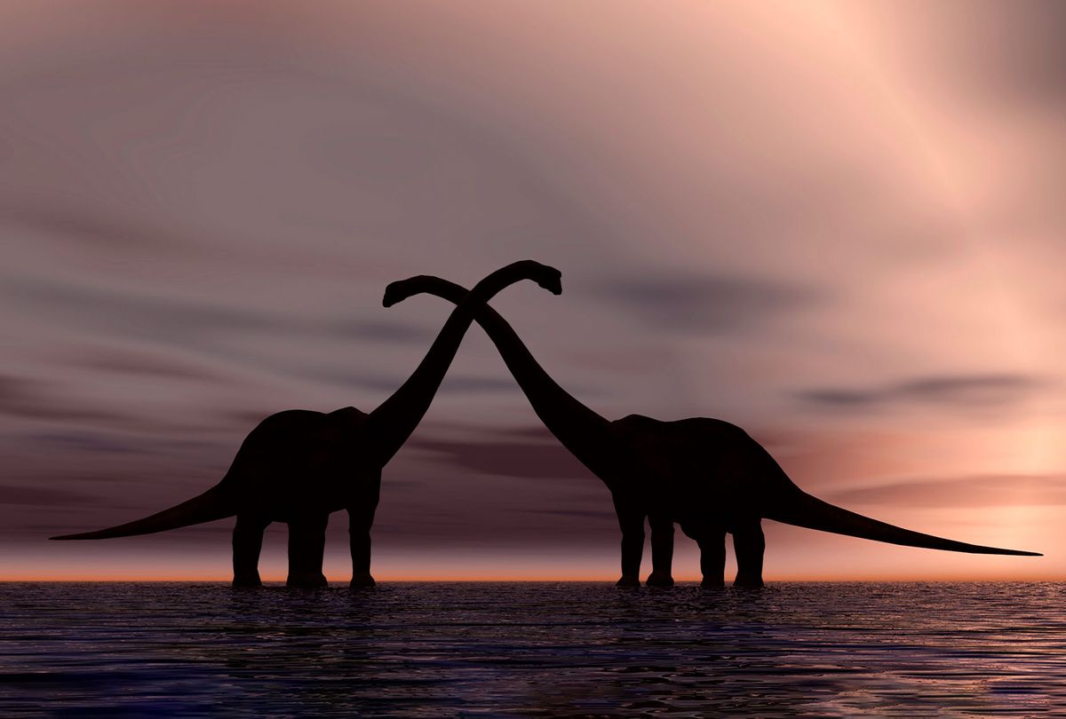 The silhouetted forms of a pair of courting sauropod dinosaurs (Getty Images)