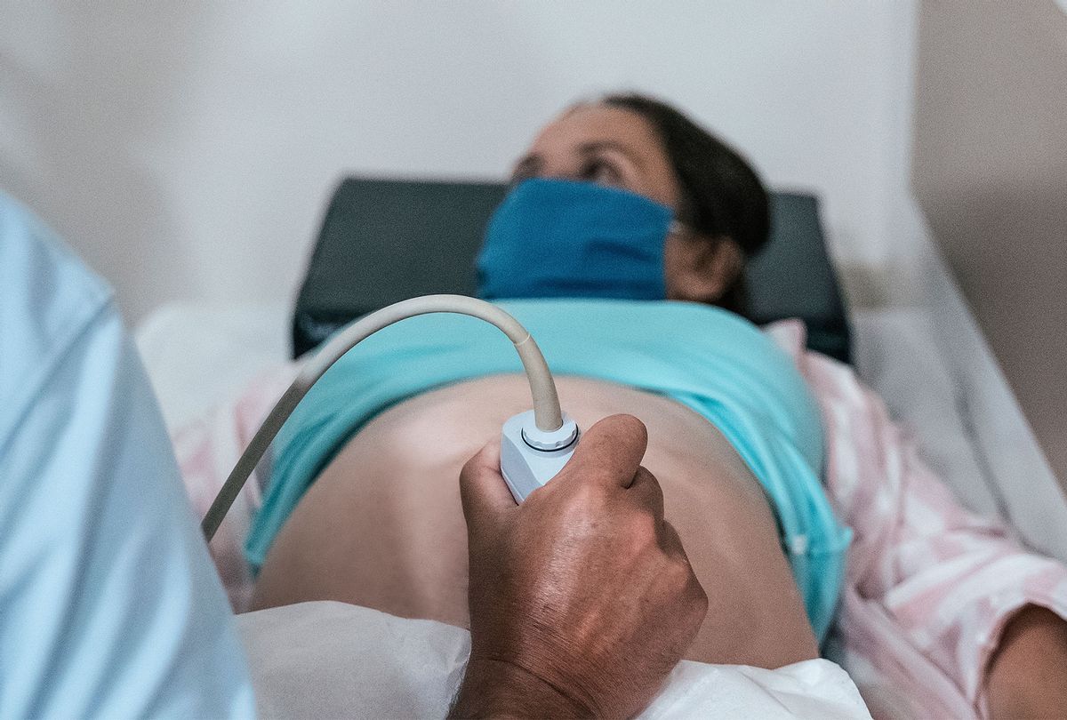 Young pregnant woman being examined during pregnancy while coronavirus pandemic (Getty Images)