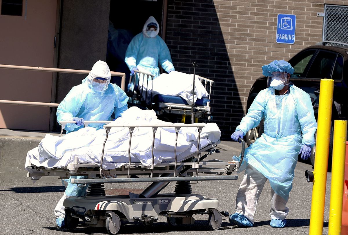 Health officials carry a dead body of coronavirus (Covid-19) victim on a stretcher to container morgues by the Wyckoff Heights Medical Center in Brooklyn, New York City, United States. (Tayfun Coskun/Anadolu Agency via Getty Images)
