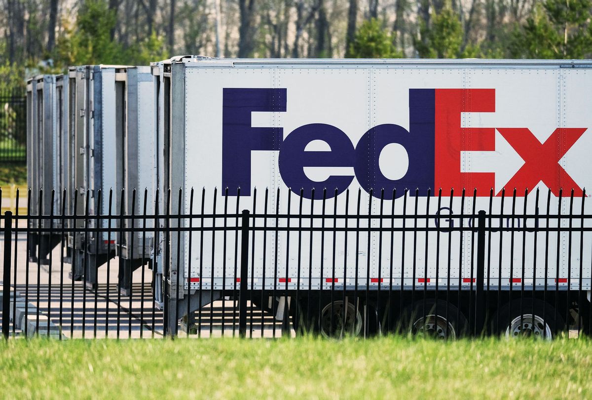 FedEx trailers are parked at the site of a mass shooting at a FedEx facility in Indianapolis, Indiana, on April 16, 2021. - At least eight people were killed at the facility late April 15 by a gunman, who is believed to have then turned the gun on himself, police in Indianapolis said. Four people with gunshot wounds were transported by ambulance, including one in critical condition, police said. Three were transported with other injuries, while two were treated at the scene and then released. (JEFF DEAN/AFP via Getty Images)