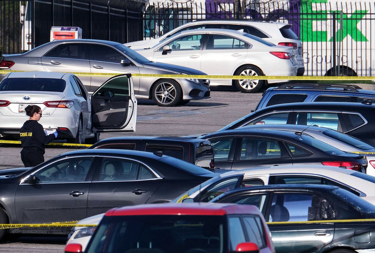 A crime lab technician (L) works in the parking lot of the site of a mass shooting at a FedEx facility in Indianapolis, Indiana on April 16, 2021. - A gunman has killed at least eight people at the facility before turning the gun on himself in the latest in a string of mass shootings in the country, authorities said. The incident came a week after President Joe Biden branded US gun violence an "epidemic" and an "international embarrassment" as he waded into the tense debate over gun control, a powerful political issue in the US. (JEFF DEAN/AFP via Getty Images)