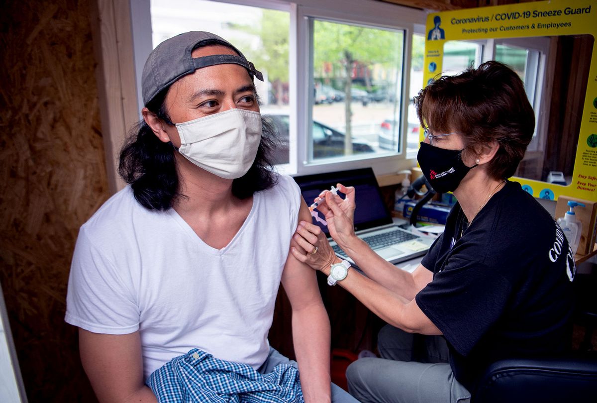 Phuc Tran of Northeast D.C., receives the Johnson & Johnson COVID-19 vaccine from Heidi Johnson, pediatric nurse practitioner, at Grubb's Pharmacy on Capitol Hill on Monday, April 12, 2021. (Tom Williams/CQ-Roll Call, Inc via Getty Images)