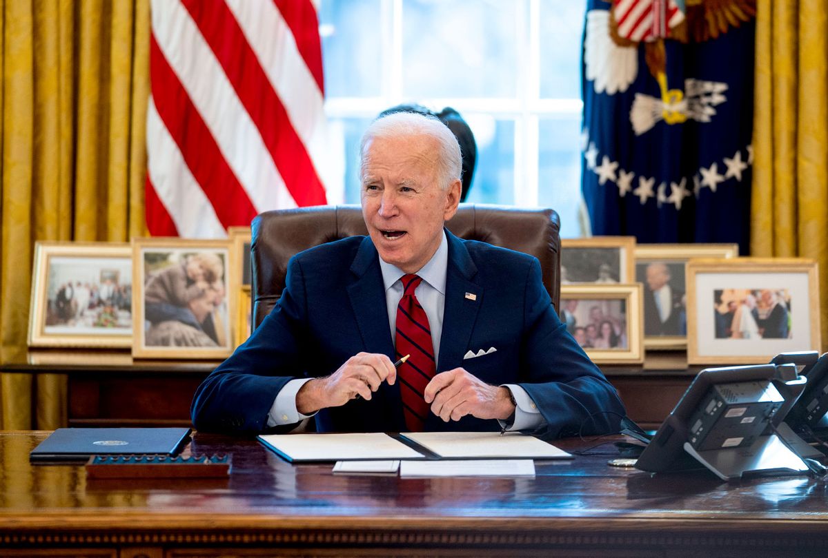 U.S. President Joe Biden signs executive actions in the Oval Office of the White House on January 28, 2021 in Washington, DC. President Biden signed a series of executive actions Thursday afternoon aimed at expanding access to health care, including re-opening enrollment for health care offered through the federal marketplace created under the Affordable Care Act. (Doug Mills-Pool/Getty Images)