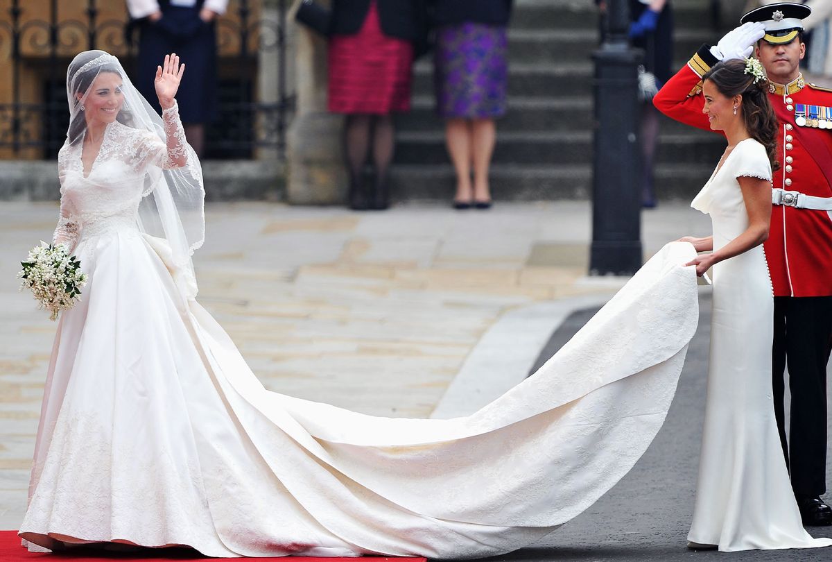Catherine Middleton waves to the crowds as her sister and Maid of Honour Pippa Middleton holds her dress before walking in to the Abbey to attend the Royal Wedding of Prince William to Catherine Middleton at Westminster Abbey on April 29, 2011 in London, England. (Pascal Le Segretain/Getty Images)