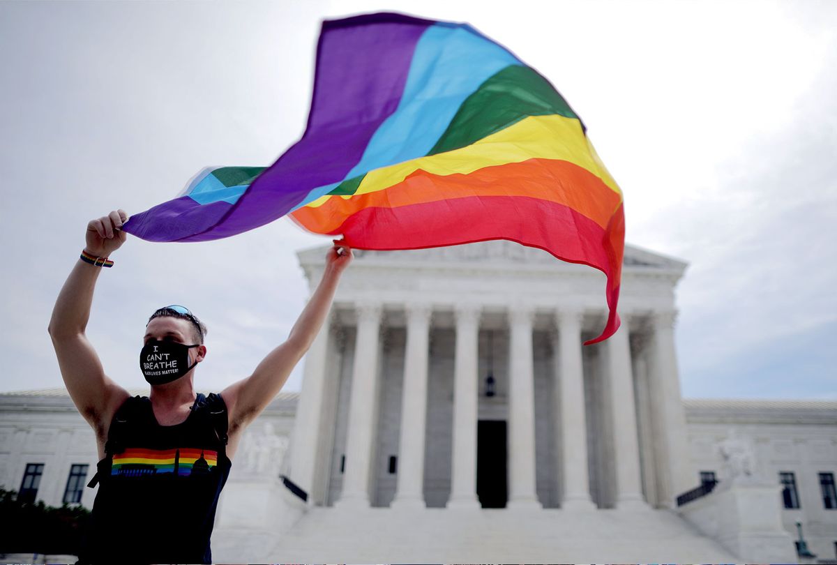 Joseph Fons holding a Pride Flag in front of the U.S. Supreme Court building (Chip Somodevilla/Getty Images)