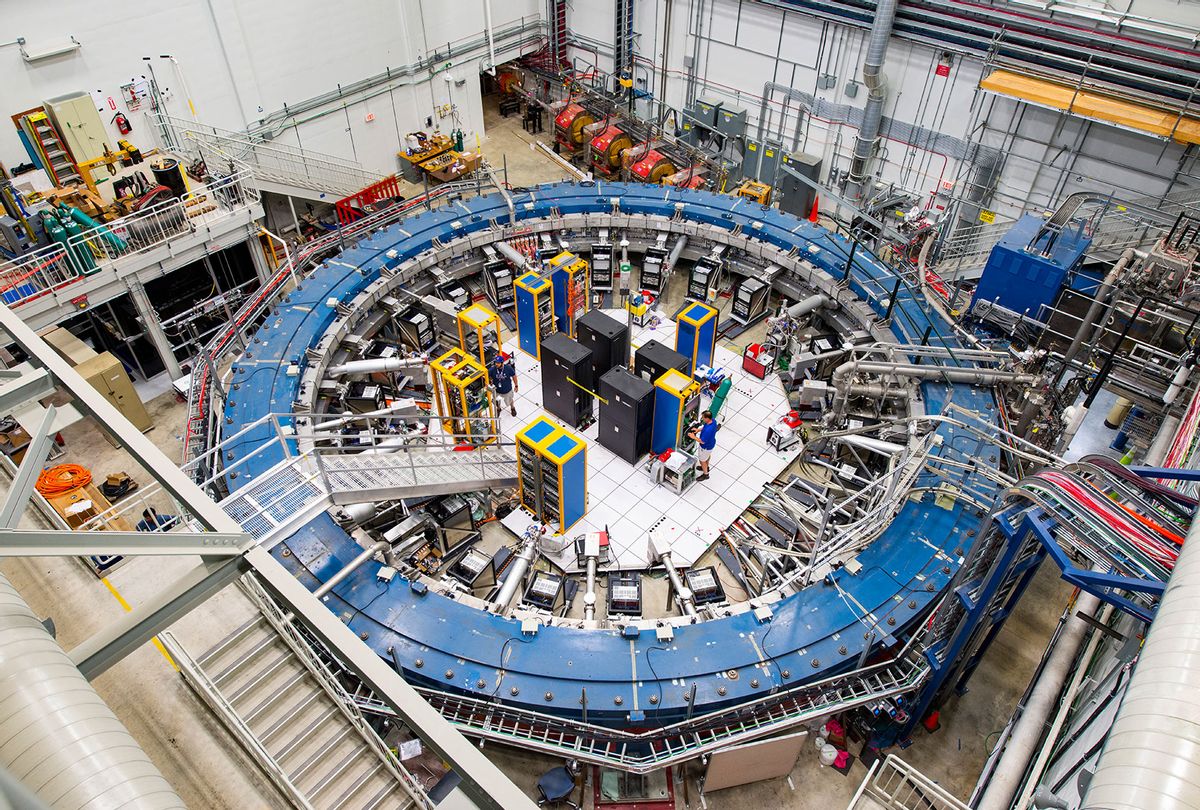he Muon g-2 ring sits in its detector hall amidst electronics racks, the muon beamline, and other equipment. This impressive experiment operates at negative 450 degrees Fahrenheit and studies the precession (or wobble) of muons as they travel through the magnetic field. (Reidar Hahn/Fermilab)