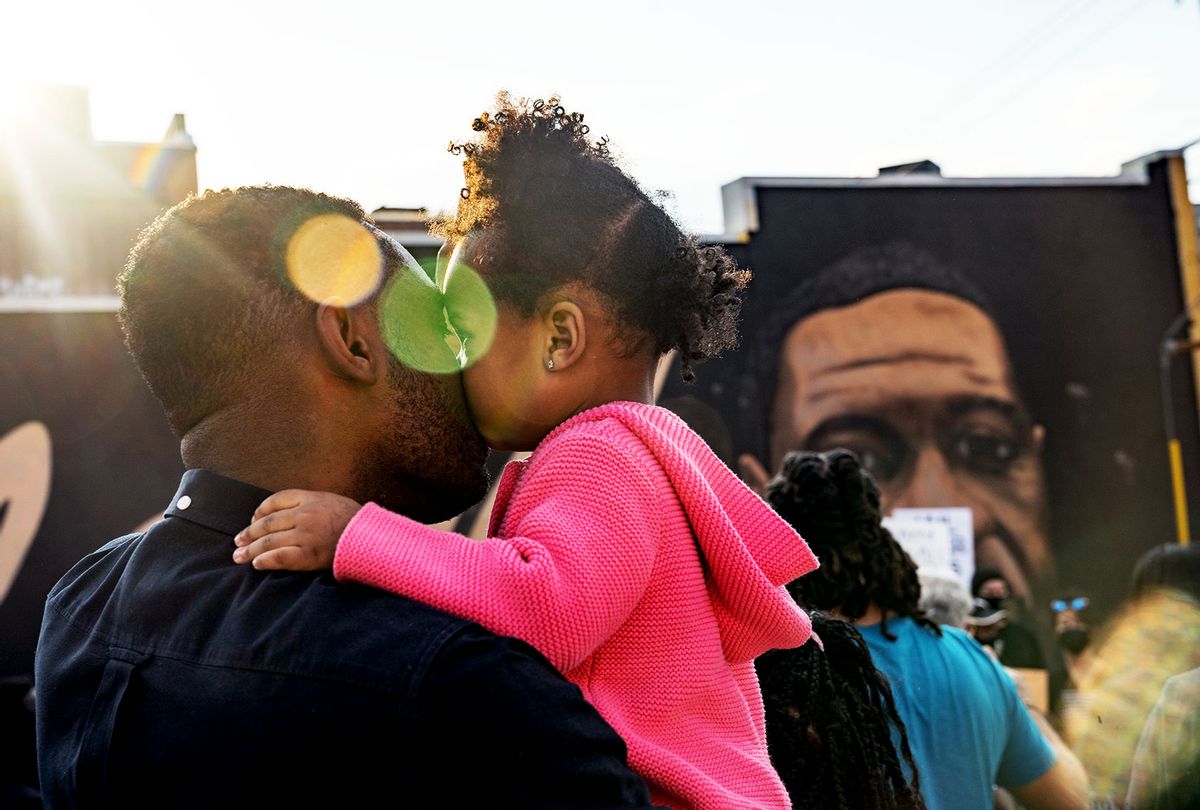 OJ Adeyemi and daughter Adenike listen to people speak before they march through the streets after the verdict was announced for Derek Chauvin on April 20, 2021 in Atlanta, United States. Former police officer Derek Chauvin was on trial on second-degree murder, third-degree murder and second-degree manslaughter charges in the death of George Floyd May 25, 2020. After video was released of then-officer Chauvin kneeling on Floyds neck for nine minutes and twenty-nine seconds, protests broke out across the U.S. and around the world. The jury found Chauvin guilty on all three charges. (Megan Varner/Getty Images)