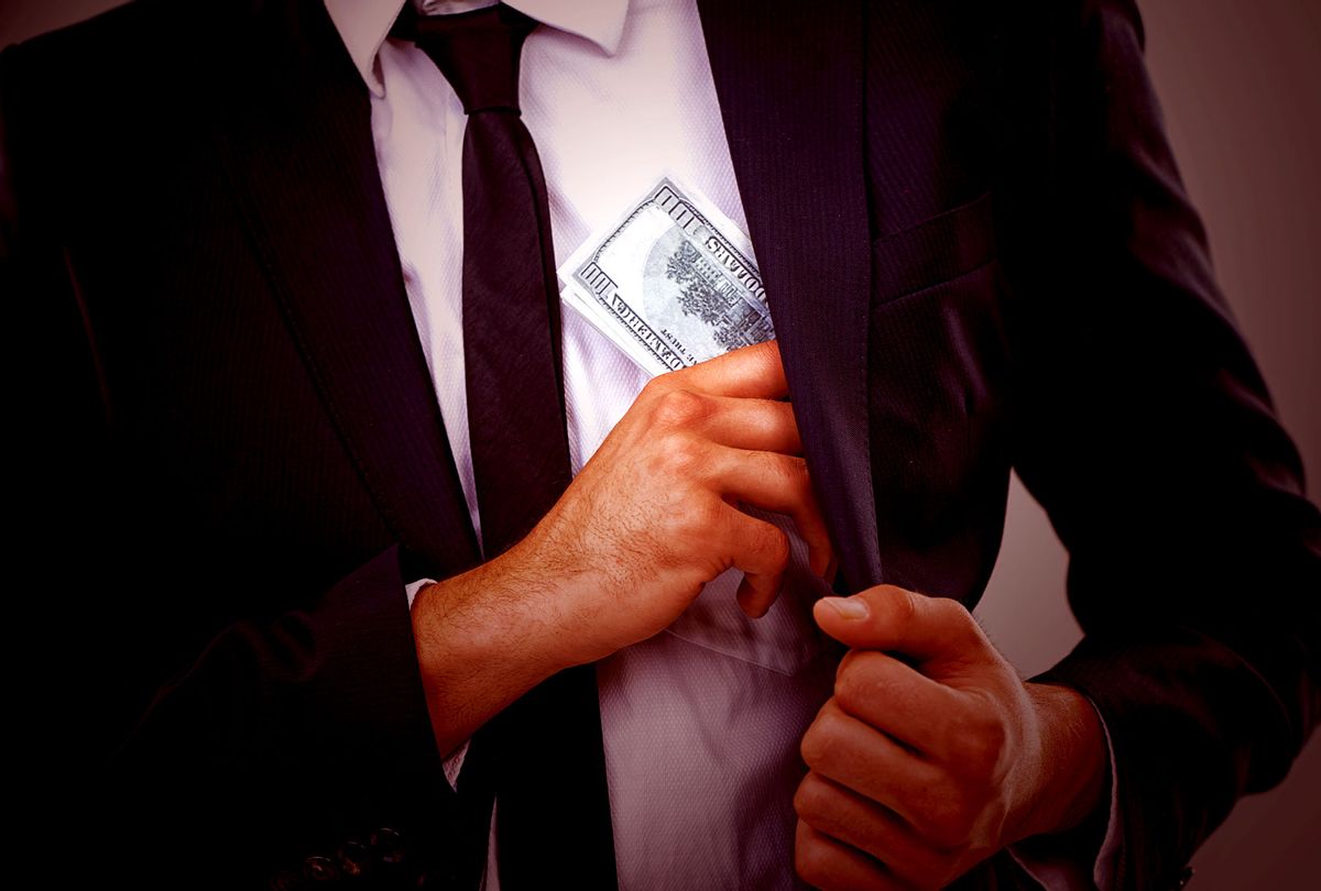 Cropped image of a businessman putting money (Getty Images)