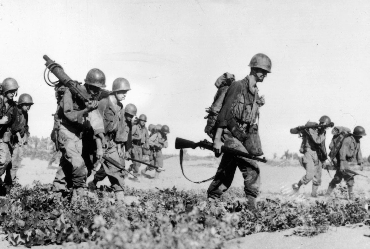 Infantrymen of the US 8th Army pour ashore in the Subic Bay area of Luzon Island in the northern Philippines, en route to Manila during World War II. (Fox Photos/Getty Images)