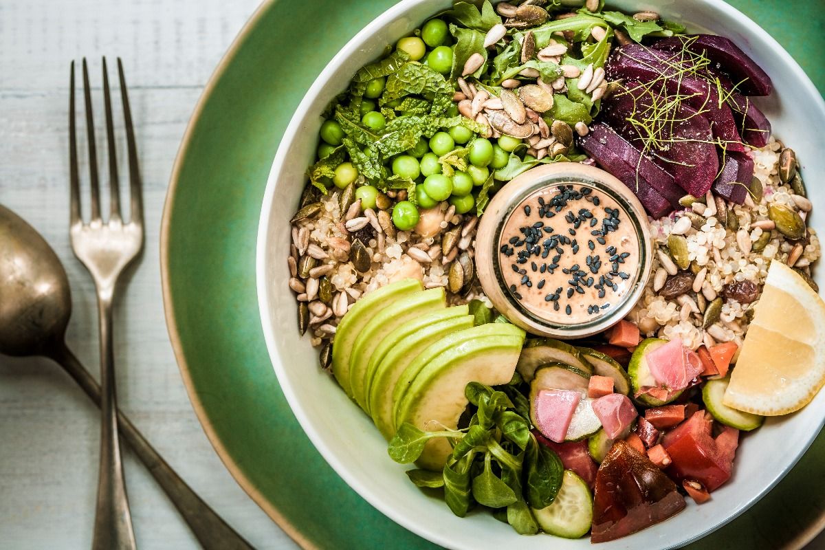 A healthy vegan/vegetarian lunch bowl of salads, grains, seeds, vegetables, avocado slices and a rich peanut-miso sauce. (Getty Images)