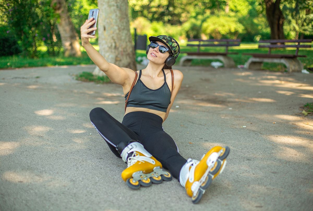 Woman takes a selfie on a break from rollerblading (Getty Images)