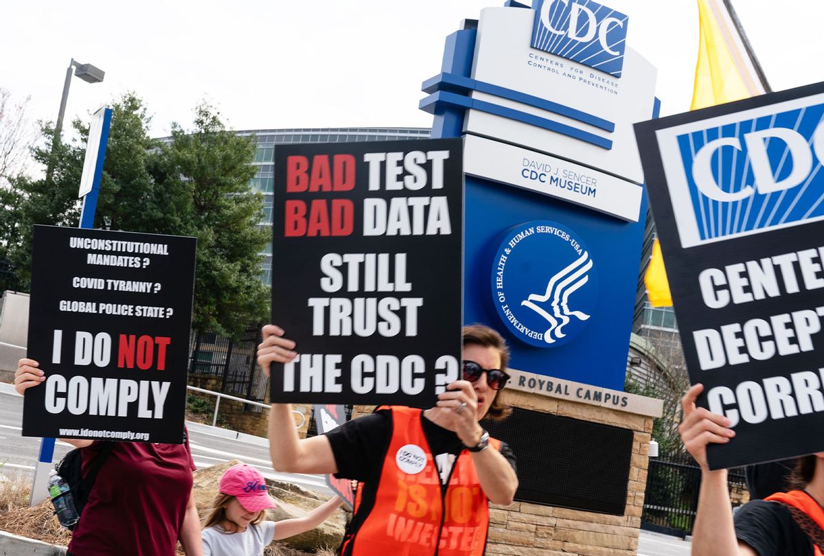 People hold signs at a protest against masks, vaccines, and vaccine passports outside the headquarters of the Centers for Disease Control (CDC) on March 13, 2021 in Atlanta, Georgia. To date, there has been over 534,000 deaths in the U.S. due to covid-19. (Elijah Nouvelage/Getty Images)