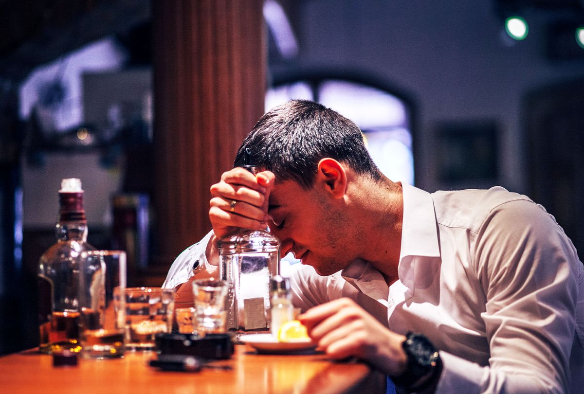 Sad drunk man sitting at counter (Getty Images)