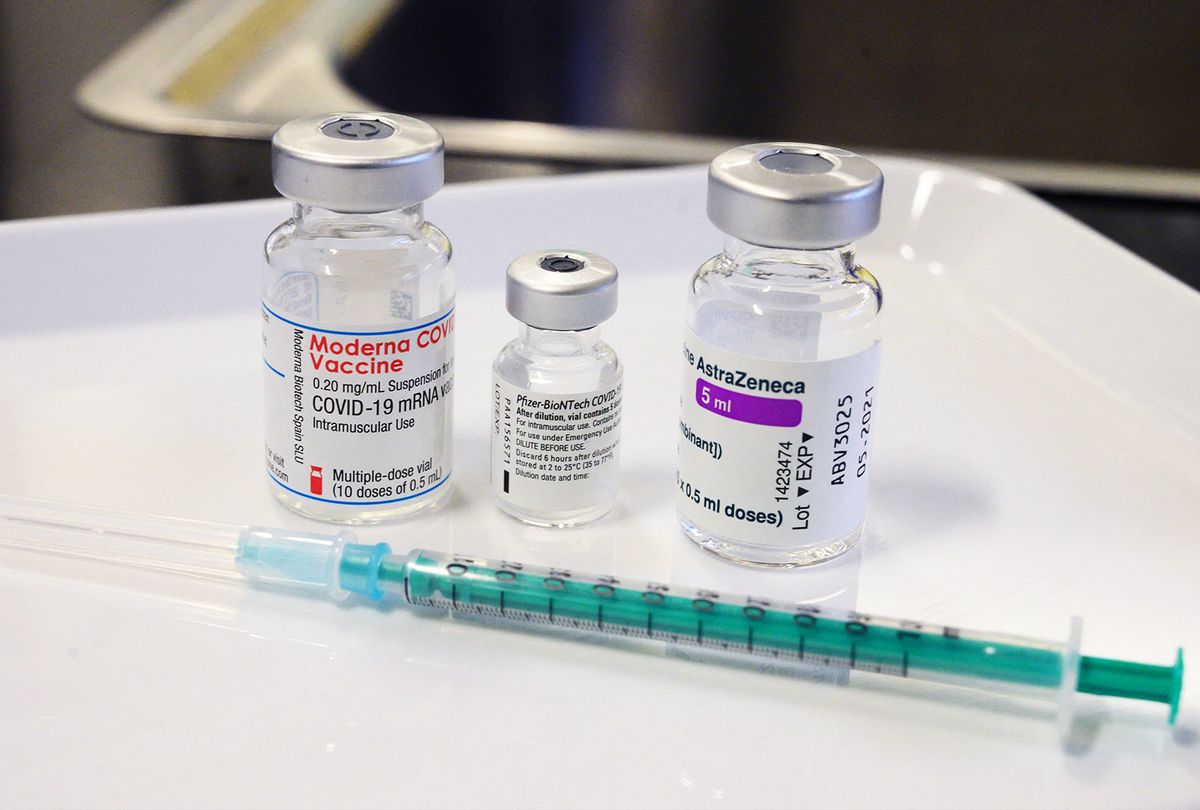 Three vials with different vaccines against Covid-19 by (L-R) Moderna, Pfizer-BioNTech and AstraZeneca stand on a table. (THOMAS KIENZLE/AFP via Getty Images)