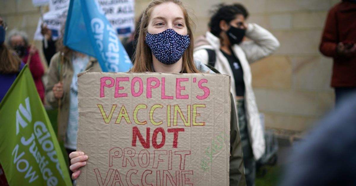 A member of the People's Vaccine, a public health advocacy campaign, protests outside an AstraZeneca site in Macclesfield, England, on May 11, 2021. The demonstrators called on the pharmaceutical giant to make the technology behind its COVID-19 vaccine free to the world. (Christopher Furlong/Getty Images)