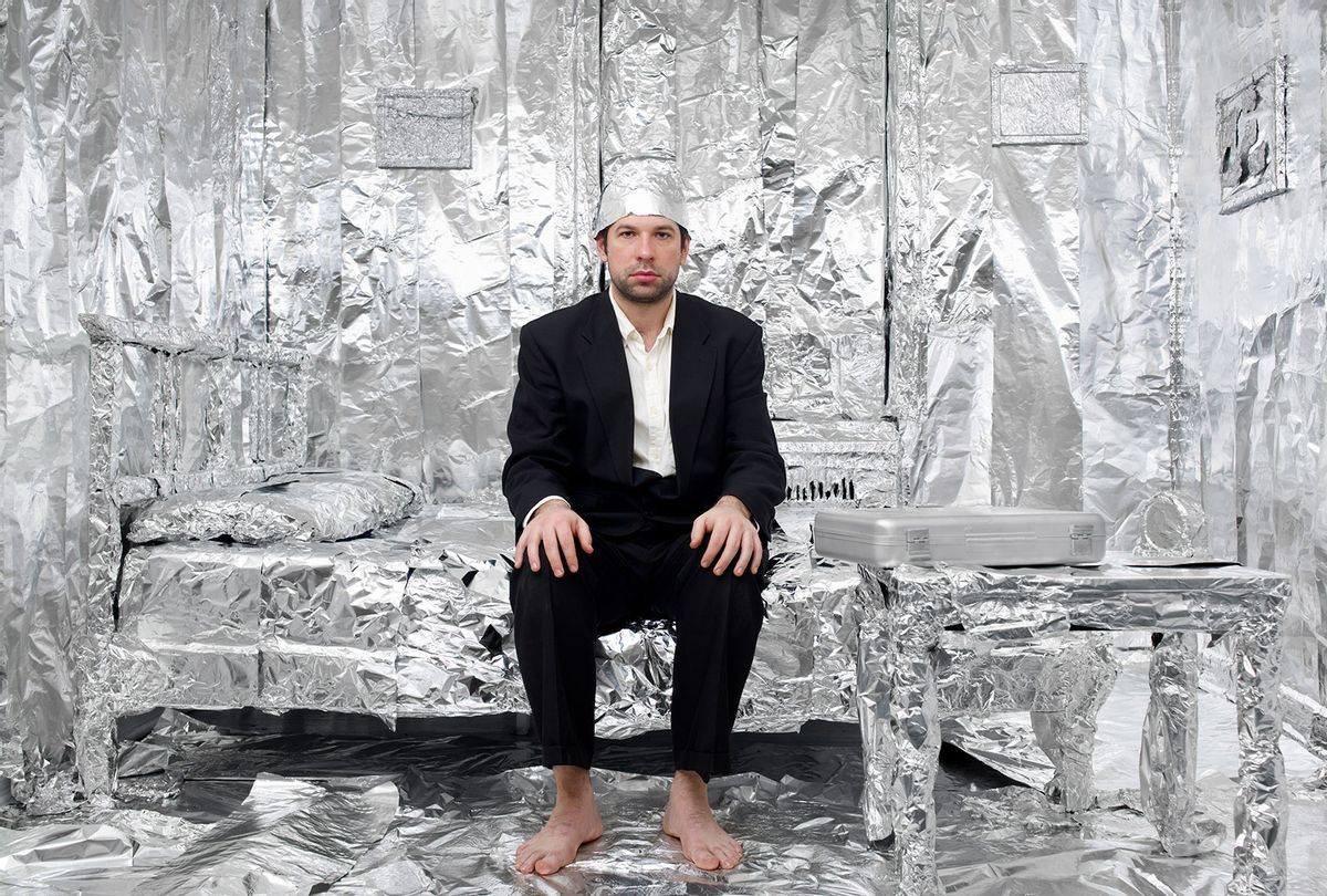 Man in tinfoil hat and tinfoil-lined bedroom (Getty Images/Matt Carr)