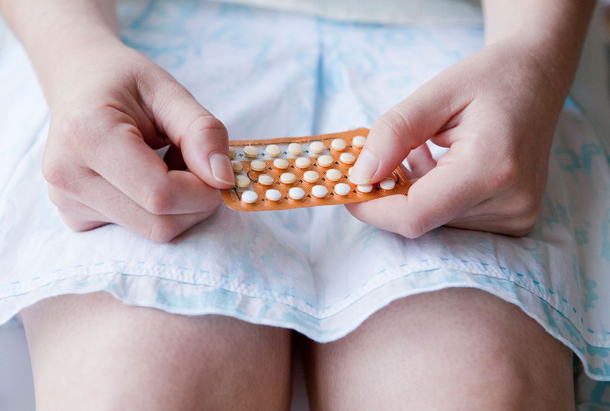 Young woman holding birth control pills blister pack (Getty Images/Dimitri Otis)