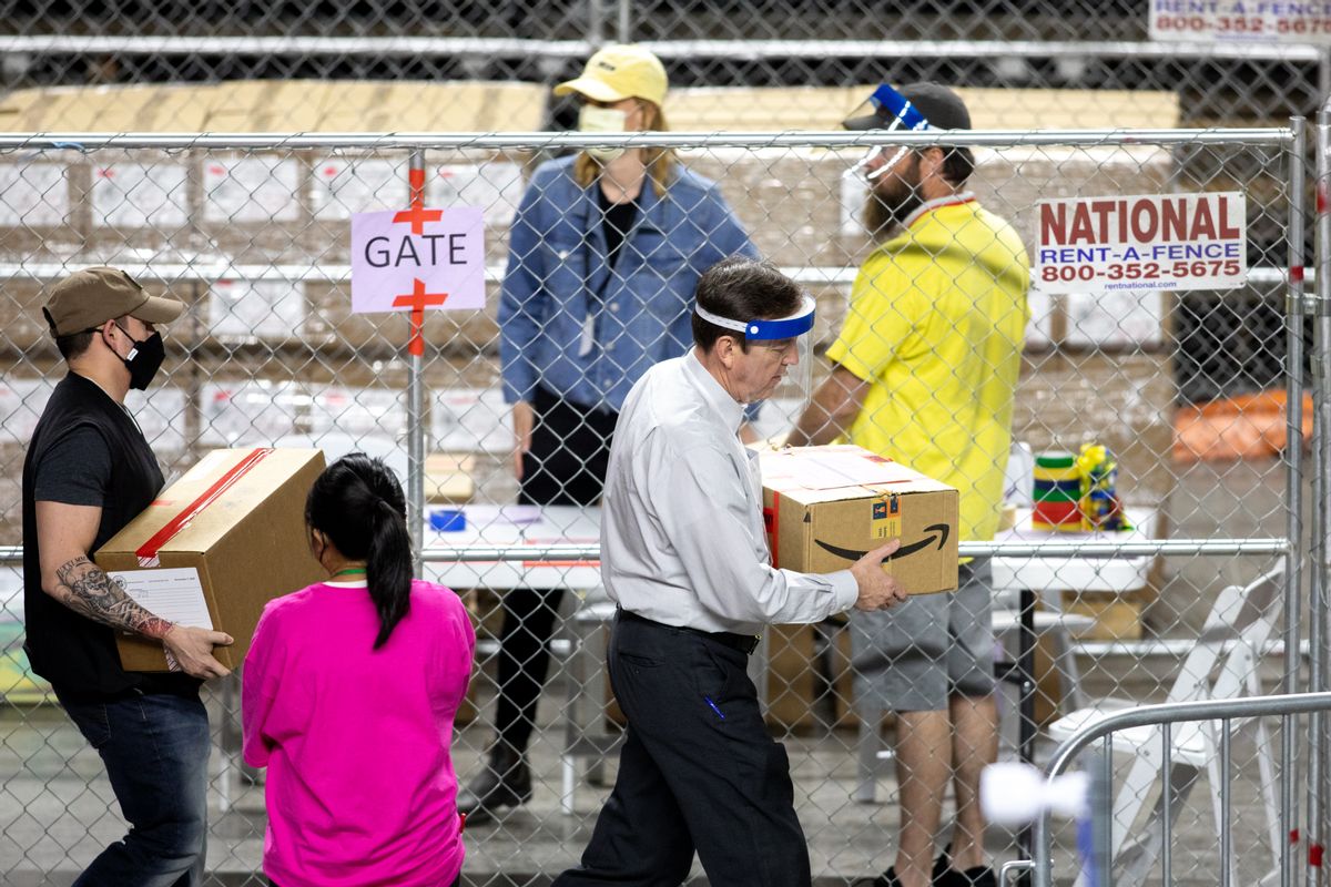 Former Secretary of State Ken Bennett (right) works to move ballots from the 2020 general election at Veterans Memorial Coliseum on May 1, 2021 in Phoenix, Arizona. (Courtney Pedroza/Getty Images)