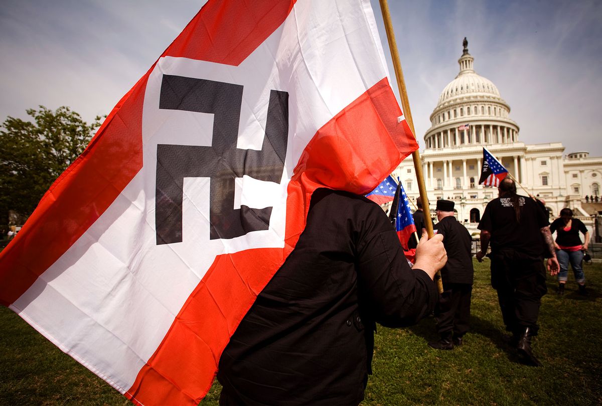 Members of the National Socialist Movement (NSM) wave American Flags and NSM flags as they march from the Washington Monument to the grounds of the United States Capitol Building on April 19, 2008 in Washington, DC. Between 30-40 members of the group marched to bring attention to their views on illegal immigration and the city had about 1200 police officers on duty. (David S. Holloway/Reportage by Getty Images)