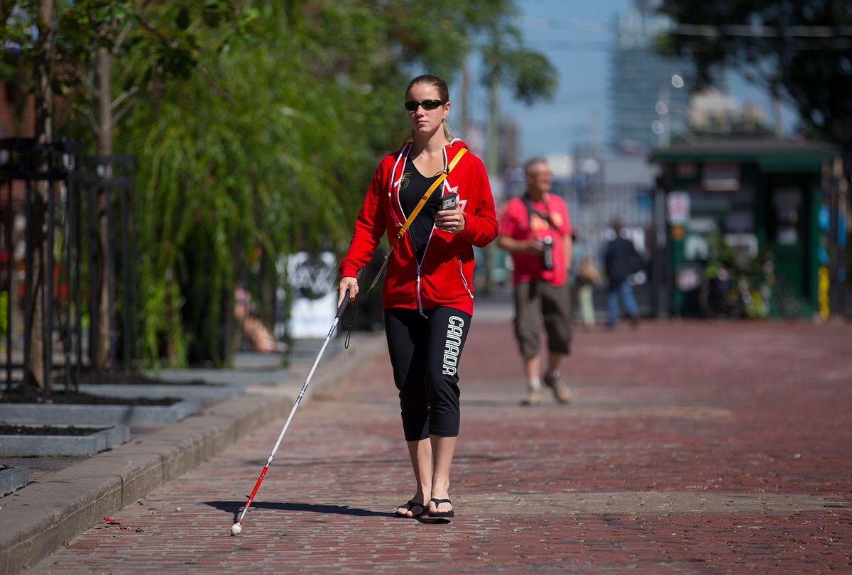 Parapan Athlete Tiana Knight demonstrates Blindsquare, an iPhone app that helps blind people by voicing out what's around them. (Chris So/Toronto Star via Getty Images)