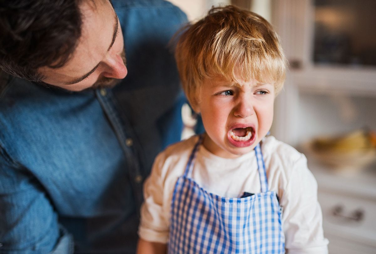 Toddler crying, being consoled by father (Getty Images/Halfpoint Images)