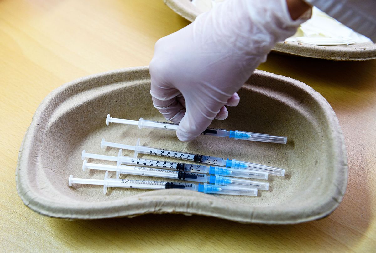 A doctor prepares syringes that contain the Pfizer/BioNTech vaccine against Covid-19 at a mobile vaccination center in the Markkleeberg suburb town hall on May 10, 2021 in Leipzig, Germany. Germany has succeeded in accelerating its nationwide vaccinations in recent weeks. Approximately one third of the population has received a first dose. (Jens Schlueter/Getty Images)