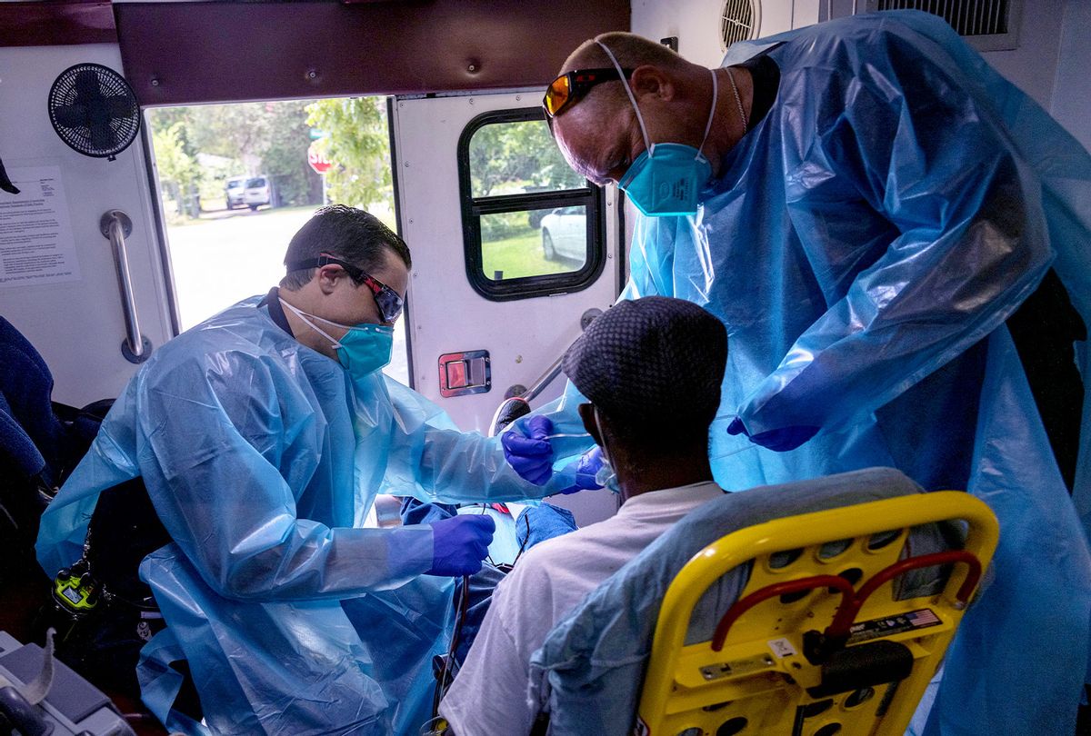 Medics from the Houston Fire Department EMS prepare to transport a man with possible Covid-19 symptoms to a hospital on August 16, 2021 in Houston, Texas. Texas' largest city is seeing a major surge of the Delta variant of the virus, taxing emergency personnel and overwhelming city hospitals. (John Moore/Getty Images)
