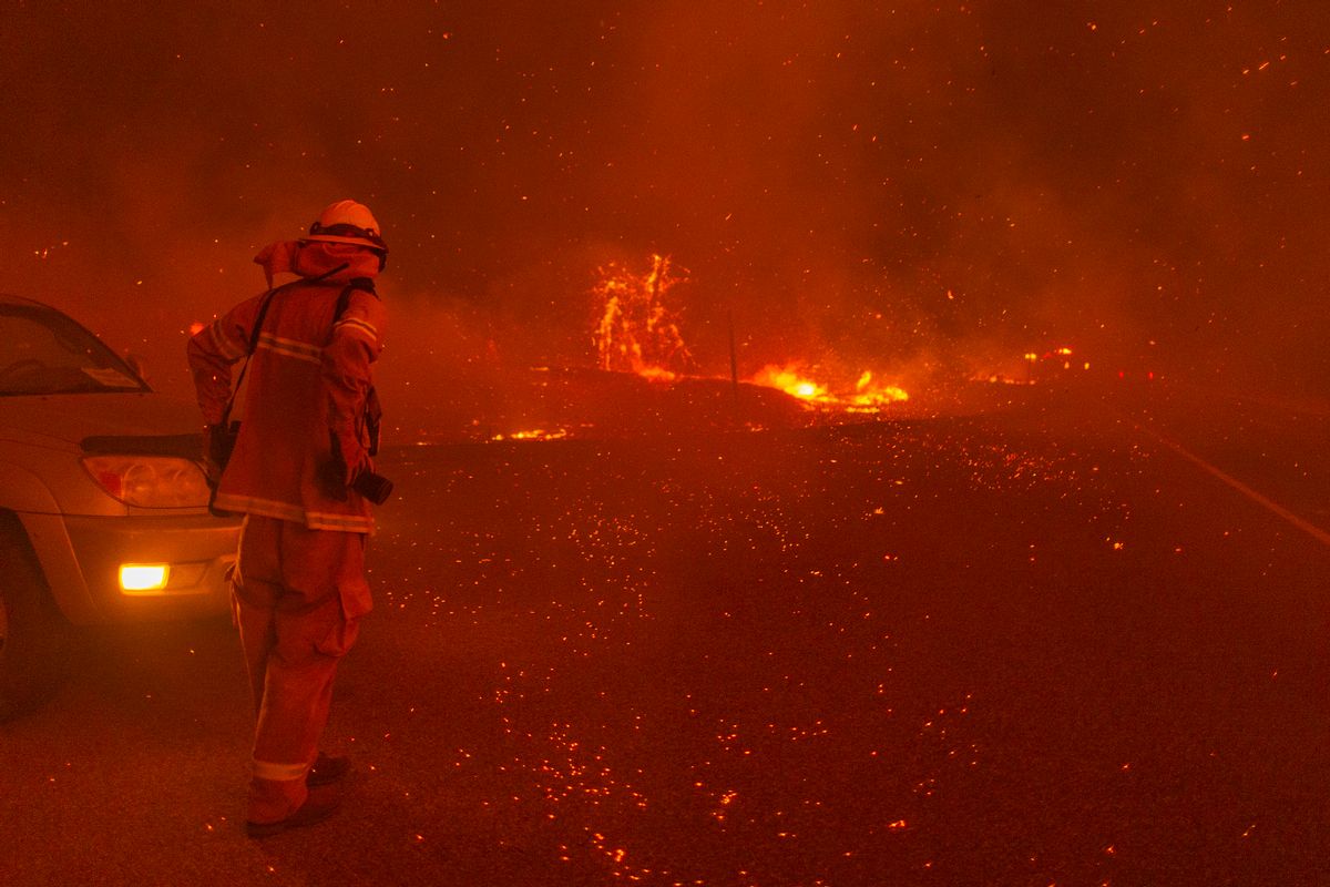 Embers fall around a photographer as the Creek Fire rapidly expands on September 8, 2020 near Shaver Lake, California. (Photo by David McNew/Getty Images)