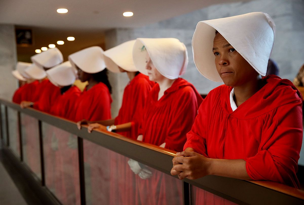 Protesters dressed in The Handmaid's Tale costume, protest outside the hearing room where Supreme Court nominee Judge Brett Kavanaugh will testify before the Senate Judiciary Committee during his Supreme Court confirmation hearing in the Hart Senate Office Building on Capitol Hill September 4, 2018 in Washington, DC.  (Win McNamee/Getty Images)