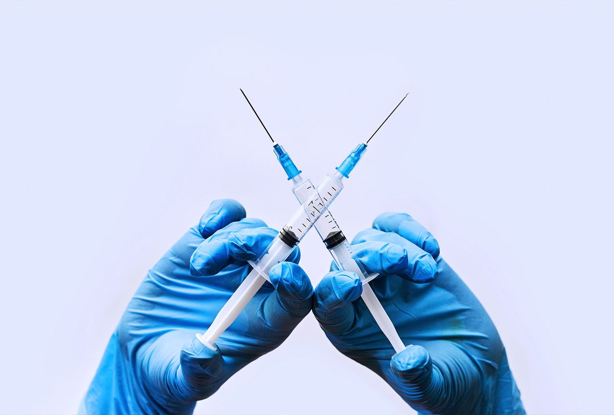 Two vaccine syringes (Getty Images/golibtolibov)