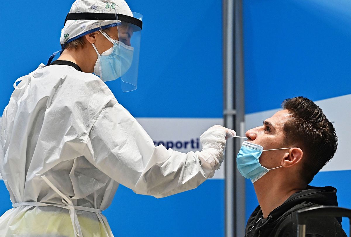 A passenger who just landed from New York on an Alitalia flight undergoes a rapid antigen swab test for COVID-19 on December 9, 2020 at a testing station set up at Rome's Fiumicino airport. (ANDREAS SOLARO/AFP via Getty Images)