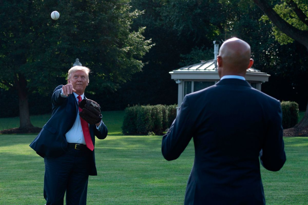 President Donald Trump, left, plays ball with Mariano Rivera, the MLB Hall of Fame closer from the Yankees, during a Major League Baseball Opening Day event at the White House in Washington, DC, on July 23, 2020. (JIM WATSON/AFP via Getty Images)