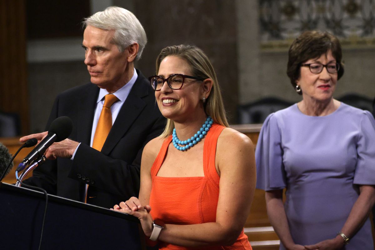Sen. Kyrsten Sinema, D-Ariz., center, answers questions from members of the press after a procedural vote on a bipartisan infrastructure bill on July 28, 2021. (Alex Wong/Getty Images)