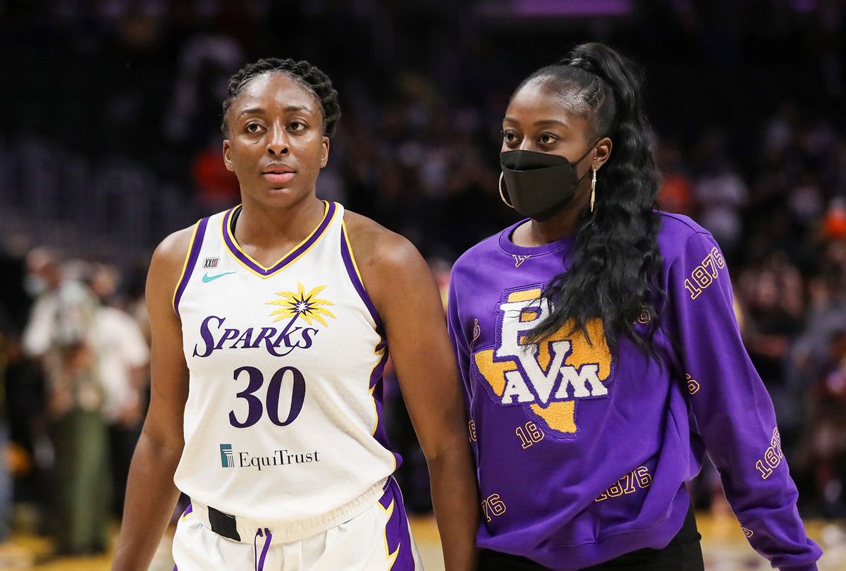 Forward Nneka Ogwumike #30 and forward/center Chiney Ogwumike #13 of the Los Angeles Sparks walk to greet fans after the game against the Seattle Storm at Staples Center on September 12, 2021 in Los Angeles, California. (Meg Oliphant/Getty Images)