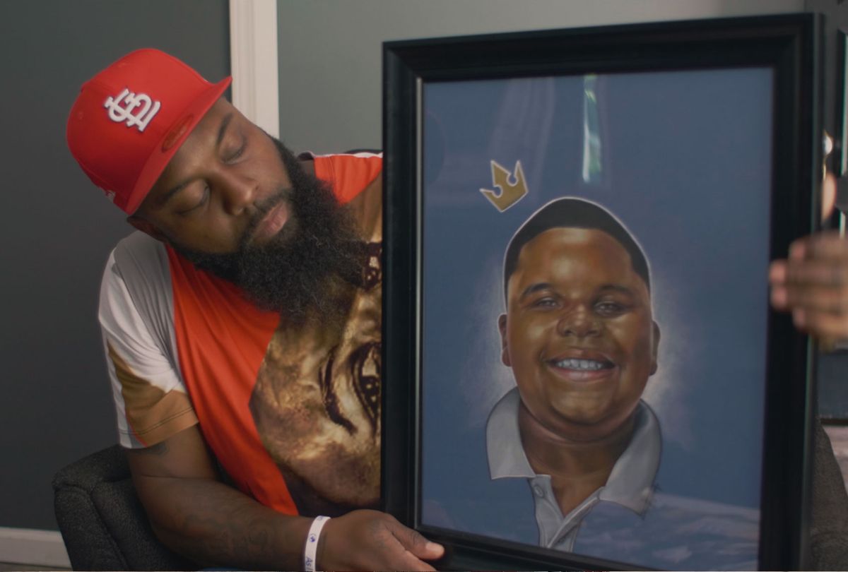 Michael Brown Sr. holds a painting of Jr. donated by an artist on "Ferguson Rises" (Rafael Roy/PBS)