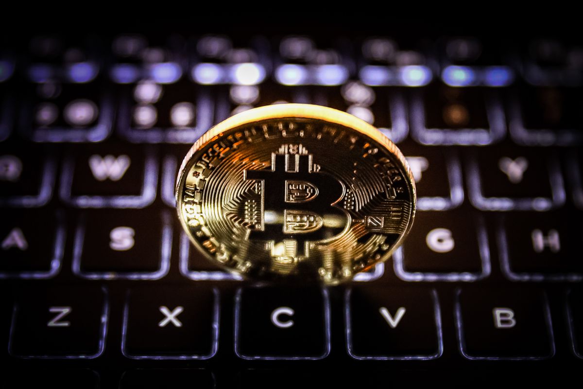 A visual representation of a Bitcoin cryptocurrency as a gold coin on a computer keyboard. (Getty Images)