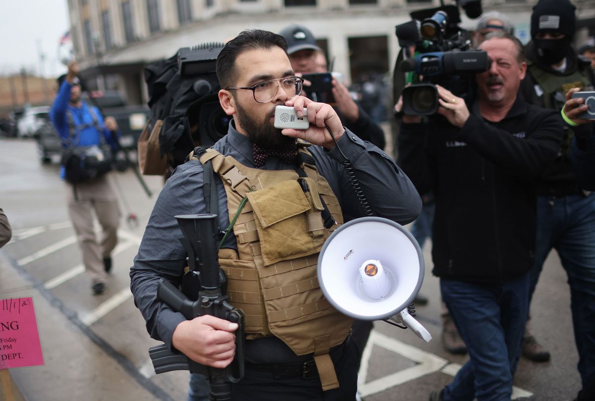 A demonstrator armed with an AR-15 style weapon protests outside of the Kenosha County Courthouse as the jury deliberates for a second day in the trial of Kyle Rittenhouse on November 17, 2021 in Kenosha, Wisconsin. (Scott Olson/Getty Images)