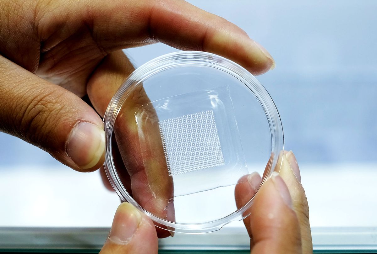 A man displays a piece of microneedle patch (SAM YEH/AFP via Getty Images)