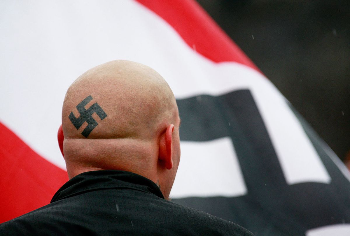 Neo-Nazi protestors organized by the National Socialist Movement demonstrate near where the grand opening ceremonies were held for the Illinois Holocaust Museum & Education Center April 19, 2009 in Skokie, Illinois. About 20 protestors greeted those who left the event with white power salutes and chants. (Scott Olson/Getty Images)