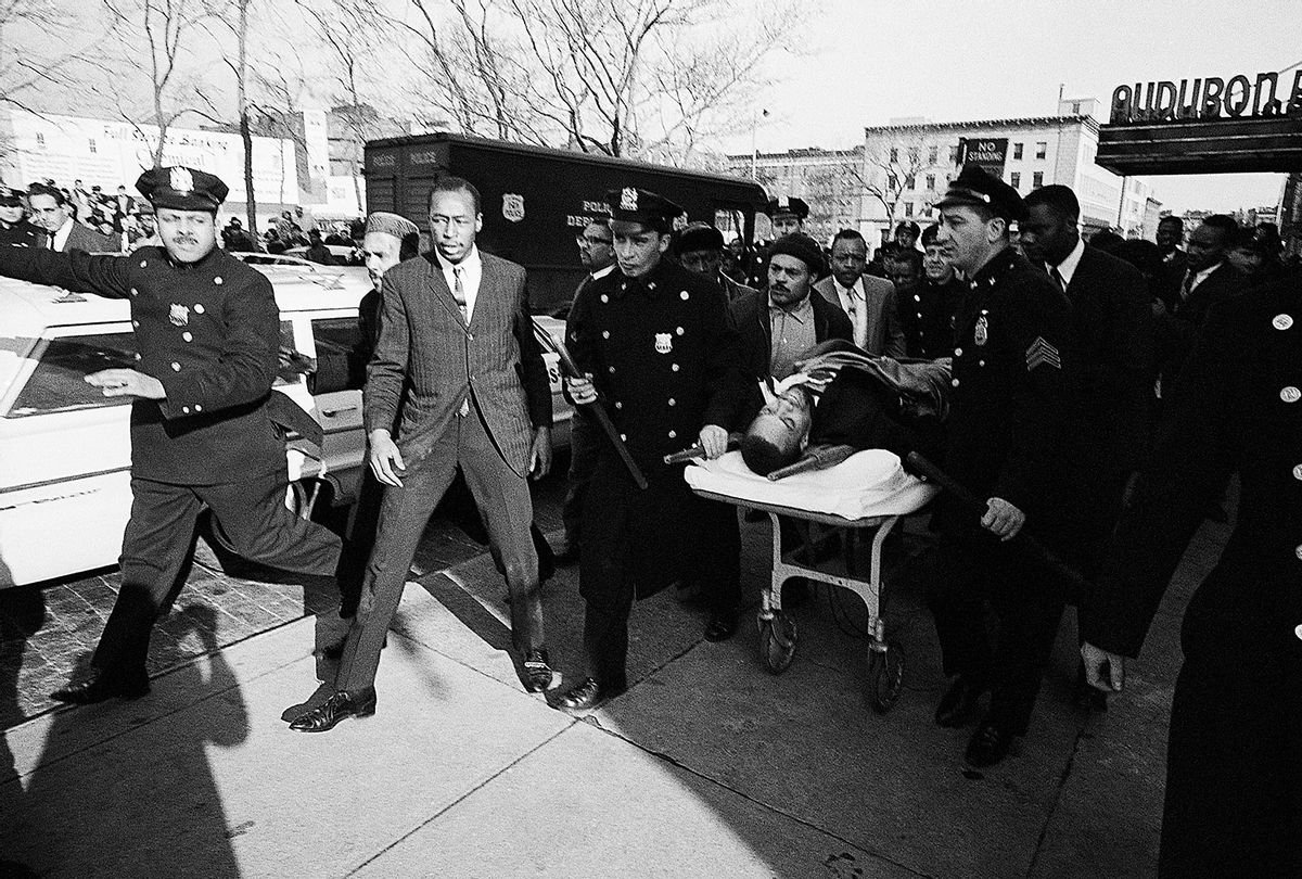 Two policemen carry stretcher bearing Negro nationalist leader Malcolm X after he was downed by an assassin's bullets at a rally on February 21st. The 39-year-old Malcolm was pronounced dead at the hospital when he was taken for treatment. The assassination of the one-time Muslim official came one week after the bombing of his home on February 13th. (Getty Images /  Bettmann / Contributor)