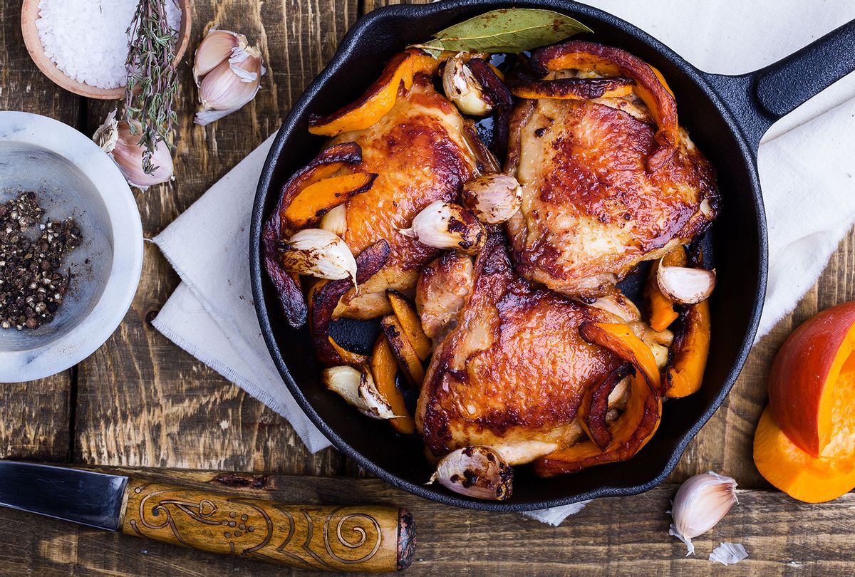 Roast chicken thoughs in a cast iron skillet (Getty Images/istetiana)