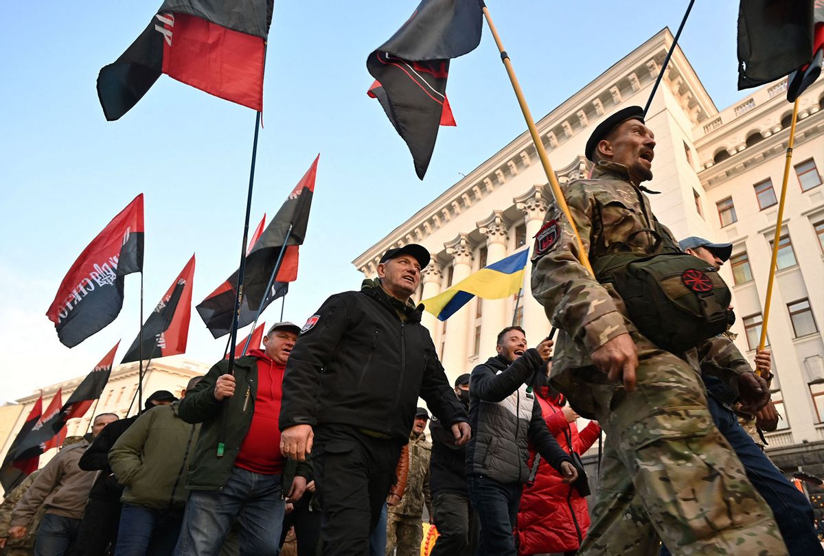 Participants of the war with Russia backed separatists on the east of Ukraine, activists of Right Sector, far-right movement hold flags as they march after their rally called "Stop the creeping occupation!" outside the office of Ukrainian President Volodymyr Zelenskyy in Kiev on November 4, 2021. - Protesters warned the authorities about the danger of increasing separatism in the regions bordering Russia which might undermine the stability and territorial integrity of Ukraine. (SERGEI SUPINSKY/AFP via Getty Images)