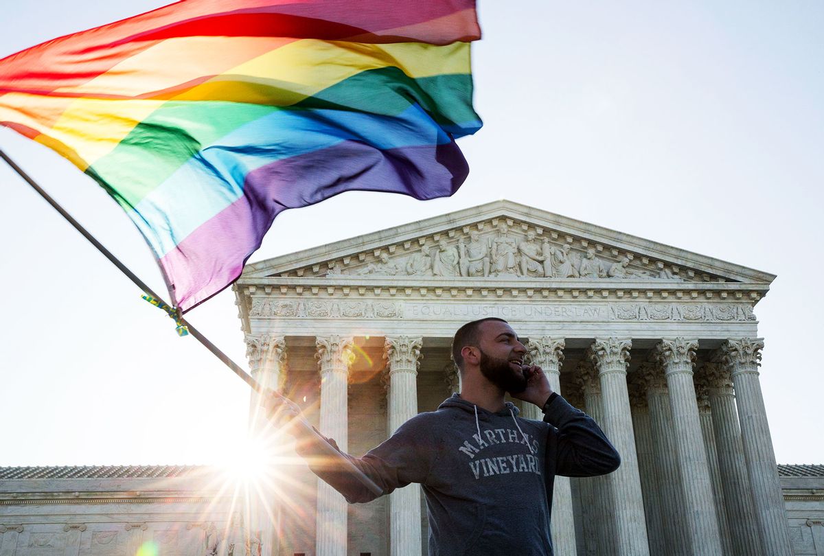 Same-sex marriage supporter waves a rainbow pride flag near the Supreme Court, April 28, 2015 in Washington, DC. (Drew Angerer/Getty Images)