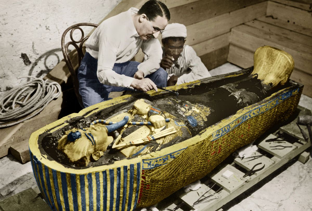 English Egyptologist ﻿Howard Carter near golden sarcophagus of Tutankhamen mummy in Egypt in 1923, colorized document (Harry Burton/Apic/Getty Images)
