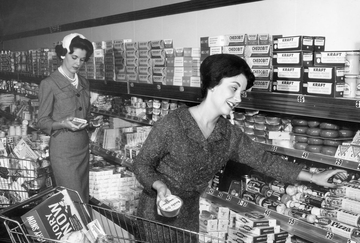 A woman smiles as she reaches for a container of Betty Crocker pizza dough mix in the dairy section of a grocery store, circa 1965 (Lambert/Getty Images)