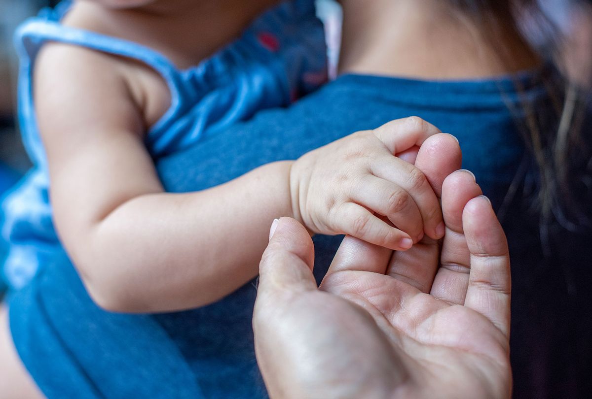 A child and parent holding hands (Getty stock photos/boonchai wedmakawand)