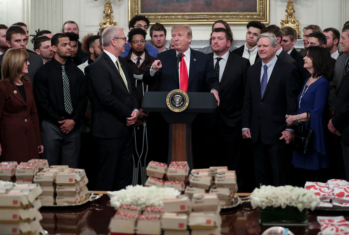 U.S. President Donald Trump speaks behind a table full of McDonald's hamburgers, Chick fil-a sandwiches and other fast food (Oliver Contreras-Pool/Getty Images)