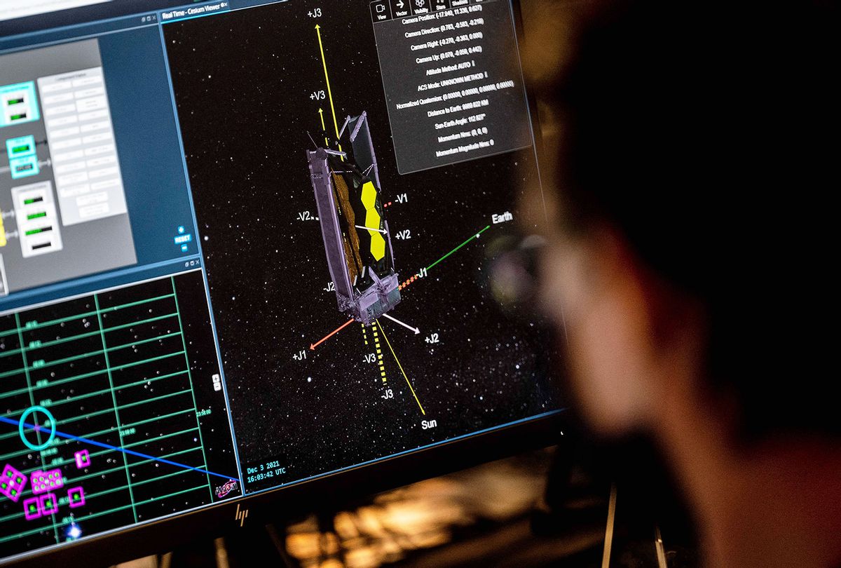 A technical drawing is seen on screen as Systems Engineers Christopher Murray (R) works at his console at the Webb Mission Office ahead of the James Web Space Telescopes launch at the Space Telescope Science Institute (STScI) in Baltimore, Maryland, on December 3, 2021. (JIM WATSON/AFP via Getty Images)