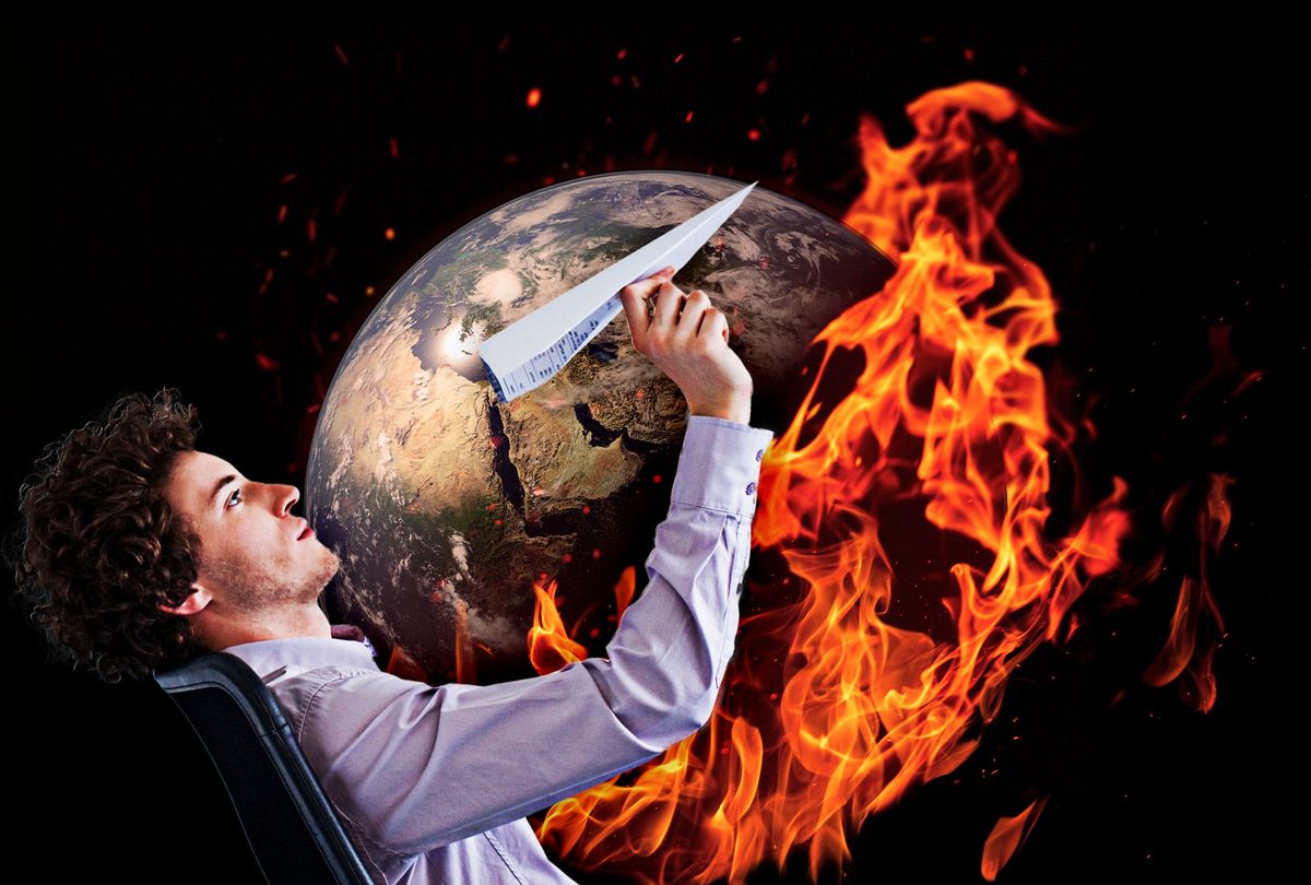 Businessman playing with a paper airplane while the world burns (Photo illustration by Salon/Getty Images)