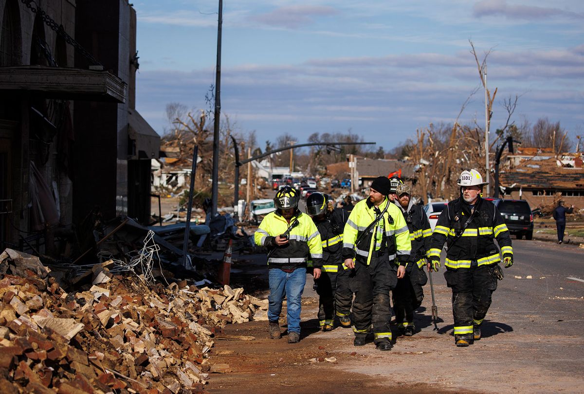 Firefighters survey tornado damages in downtown Mayfield on December 11, 2021 in Mayfield, Kentucky. Multiple tornadoes tore through parts of the lower Midwest late on Friday night leaving a large path of destruction and multiple fatalities. (Brett Carlsen/Getty Images)